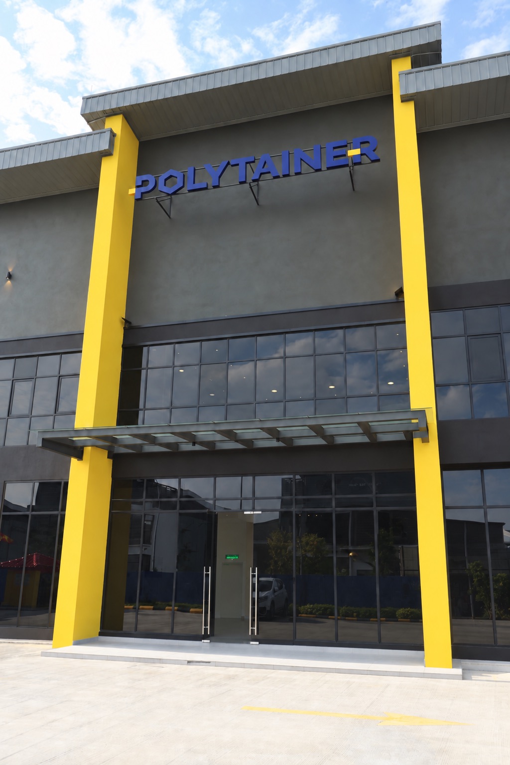 Polytainer’s Bandar Bukit Raja headquarters and factory entrance, with blue signage and yellow columns